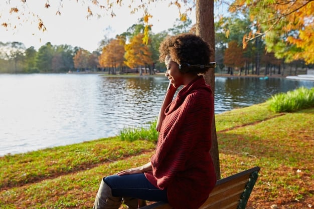 A person sitting in a peaceful setting in the US, with a warm smile on their face and their hands gently resting in their lap. They are practicing loving-kindness meditation, sending positive and compassionate thoughts to themselves and others.