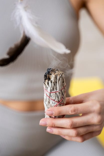 A close-up of a hand smudging a room with a sage stick, with smoke swirling around, purifying the space for meditation.