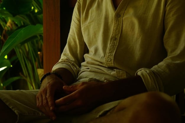 An individual sitting in a lotus position during a guided meditation session in a tranquil natural setting with soft, diffused light.