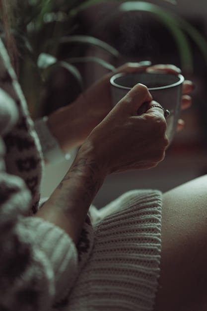 A close-up shot of hands gently holding a cup of steaming tea during a quiet morning meditation, with soft sunlight streaming through a window in the background.