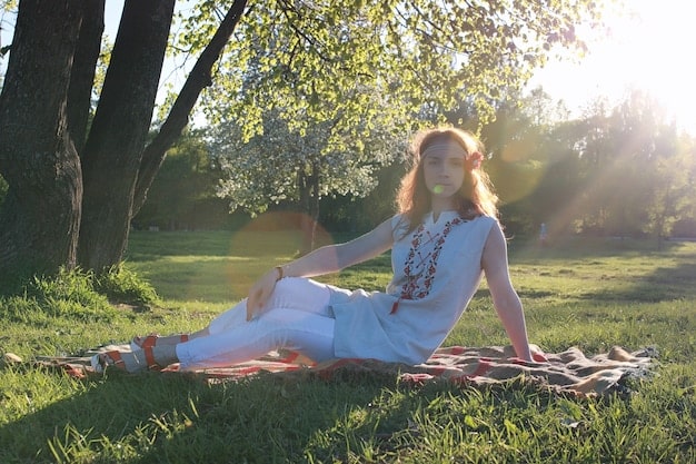 An image of a woman practicing mindful meditation in a quiet park, with sunlight filtering through the trees, symbolizing the accessibility and natural setting for meditation practice.