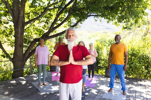 A diverse group of people practicing Tai Chi in a park at sunrise, symbolizing community, harmony, and spiritual practice.
