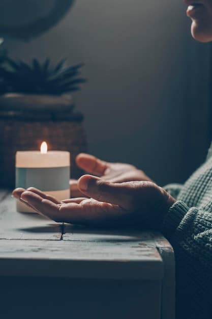 A close-up of a person's hands gently resting in their lap during meditation. The background is blurred, with soft, natural light illuminating the scene.