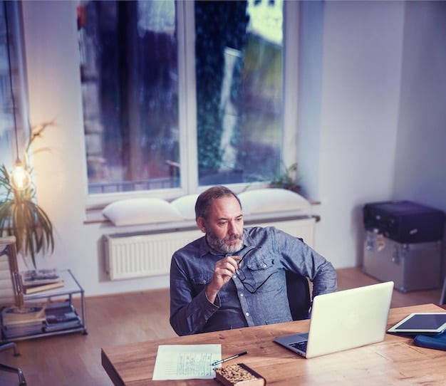 A person sitting at a desk, working on a laptop, looking focused and calm. A small meditation cushion is visible in the corner of the room, suggesting that meditation is an integrated part of their workday.
