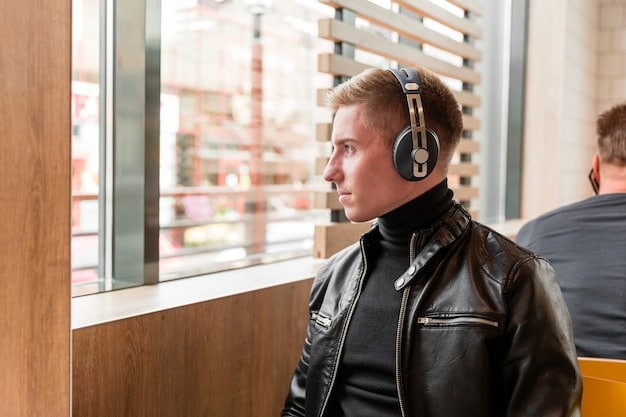 A person wearing noise-canceling headphones, looking relaxed and focused, possibly in an office or study setting