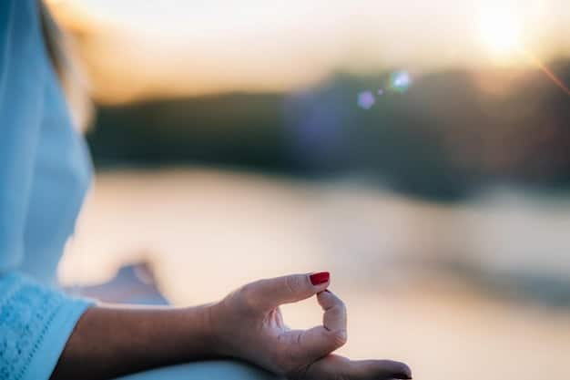A close-up shot of hands gently resting on knees during meditation, symbolizing stillness and focus. The background is blurred, emphasizing the individual's inner journey.