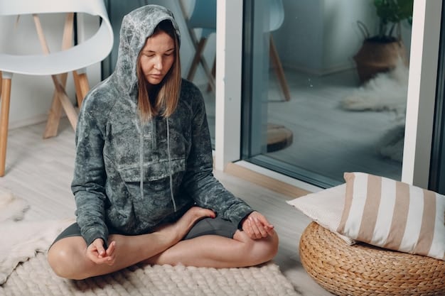 A person sitting in a comfortable position, practicing deep breathing meditation with their eyes closed, with focus on their body and internal state.