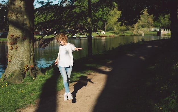 A person in comfortable clothing and shoes, walking slowly and mindfully on a paved path in a park, trees lining the path, creating a sense of peace and serenity.