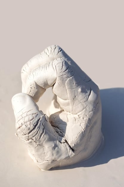 An artist's hands sculpting clay, with a radiant light focused on the sculpture, symbolizing the visualization of bringing an idea to life. The artist's face is serene and focused.