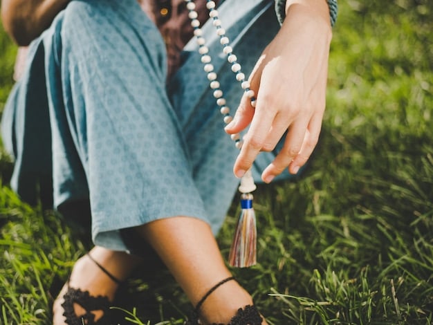 A close-up shot of a person's hands gently holding a mala (prayer beads), suggesting mindfulness and focus during meditation.