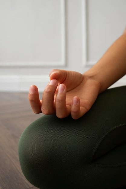 A close-up shot of a person's hands in a meditation pose. The hands are resting gently on their knees with the palms facing upwards, symbolizing openness and receptivity. The background is blurred, emphasizing the focus on inner peace and reflection.