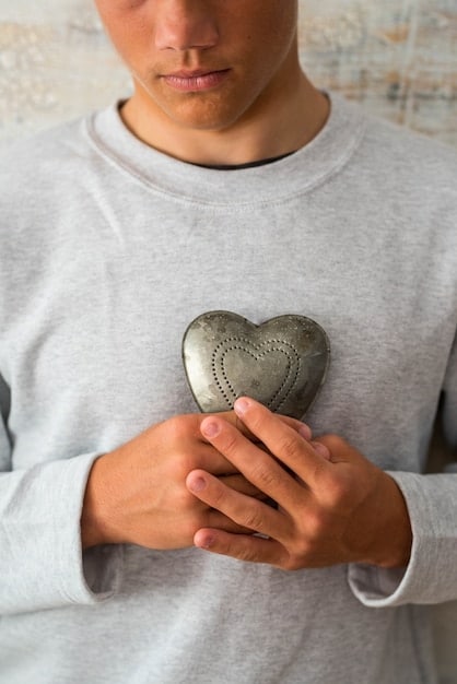 A close-up shot of hands gently holding a heart, symbolizing self-compassion and care during meditation.