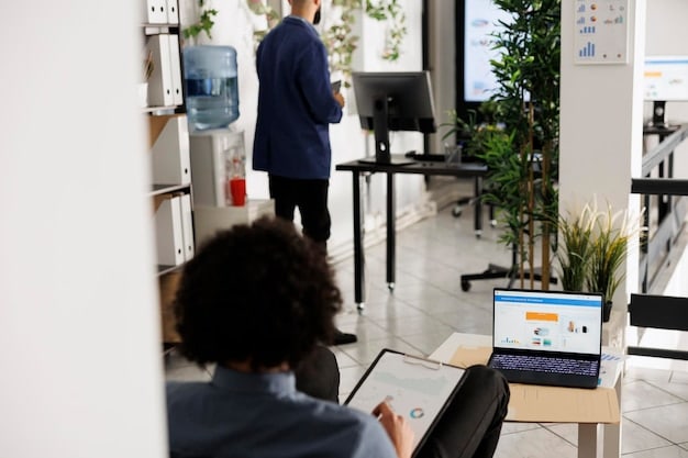 A clean, organized office setting with a Virgo employee meticulously analyzing data on multiple monitors. The décor is minimalist and efficient, reflecting the Virgo's preference for order and detail