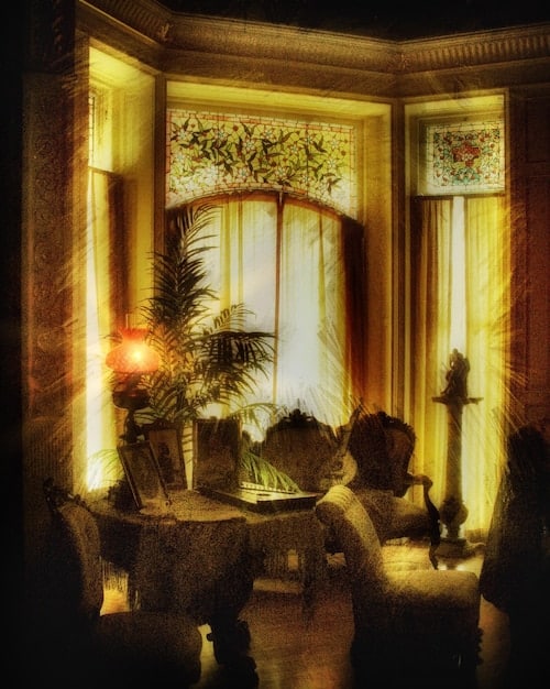 A luxurious living room with gold accents, statement lighting, and plush velvet furniture, reflecting Leo's love for drama and opulence.