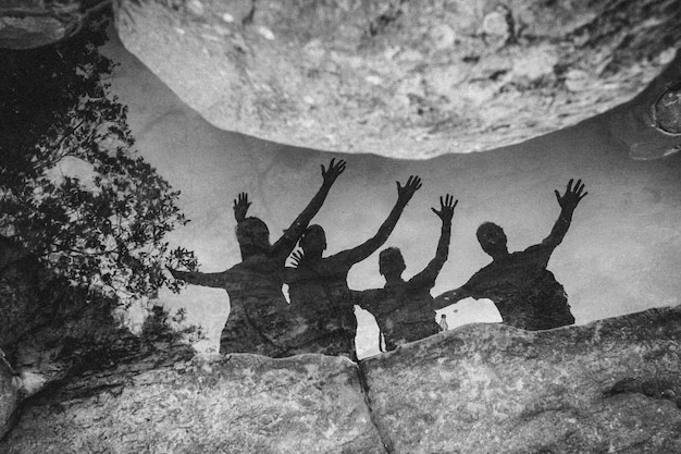 A vibrant and dynamic image of an Aries friend leading a group of friends on an adventurous outdoor activity, such as hiking or rock climbing, symbolizing their energetic and spontaneous spirit.