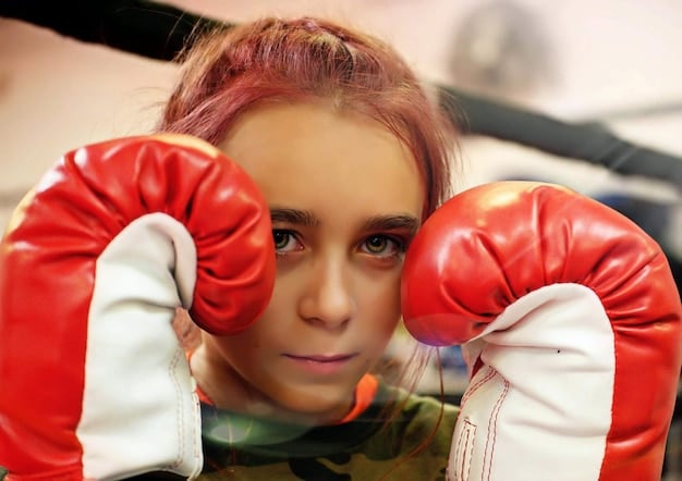 A close-up shot of an Aries individual intensely focused while practicing martial arts, showcasing their determination and physical prowess. The background is blurred to emphasize their concentration and power.