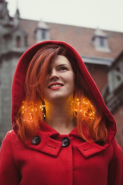 A person confidently wearing a red leather jacket paired with bold accessories such as a statement necklace. The setting is an urban environment to reflect the bold and adventurous spirit of Aries.