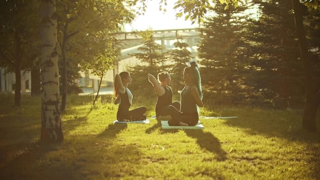 A wide-angle shot of a group of people practicing yoga outdoors in a park during sunset, with the warm sunlight casting long shadows and creating a serene atmosphere.