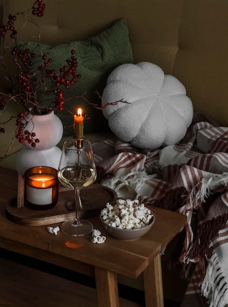 A cozy, softly lit room with candles and a comfortable chair, set up as a space for meditation and introspection during the winter solstice.
