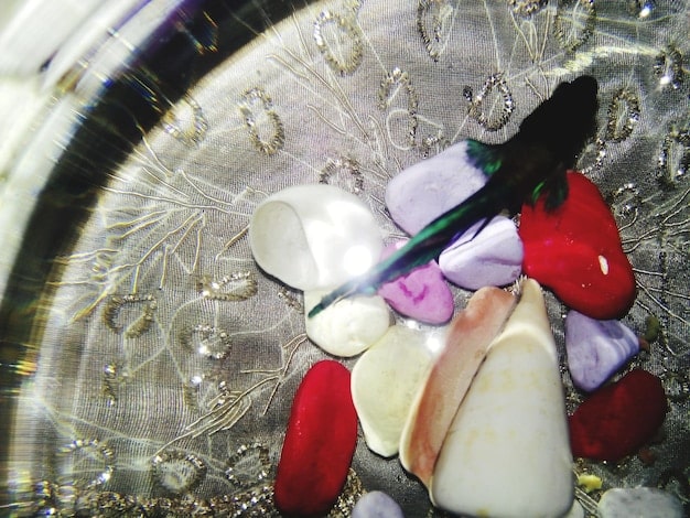 A close-up shot of various crystals arranged in a circle under the moonlight, focusing on their vibrant colors and textures, with a subtle, mystical atmosphere.