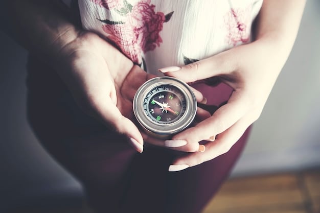 A hand gently holding a compass with a faint glowing light emanating from it, symbolizing inner guidance. The background is blurred, suggesting a focus on internal direction.