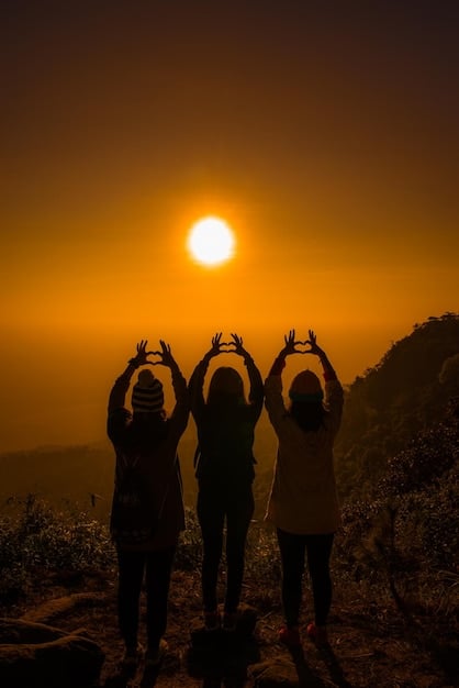 A group of diverse people holding hands in a circle, eyes closed, during a group spiritual ceremony in nature. The sun is setting, creating a warm and golden atmosphere.