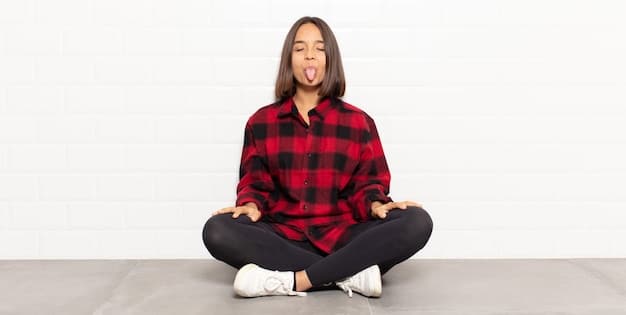 A person is sitting in a meditative pose, eyes closed, with a slight smile on their face. They are in a peaceful indoor setting, conveying a sense of calmness and inner peace despite potential challenges in their meditation practice.