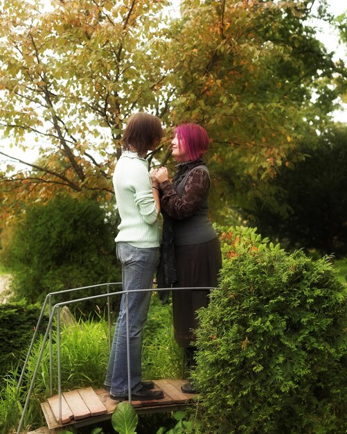 A warm and comforting scene depicting a Cancer individual lovingly tending to a home garden with their partner, symbolizing their nurturing nature and dedication to creating a harmonious environment.