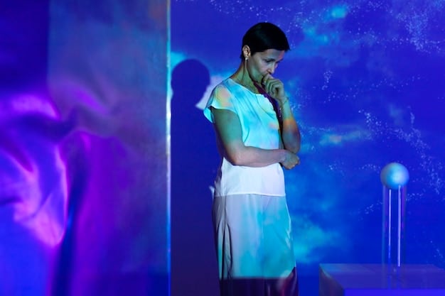 A person (gender-neutral) standing on a stage, bathed in warm light, addressing a large, attentive audience. The Leo zodiac symbol is subtly projected onto the backdrop.