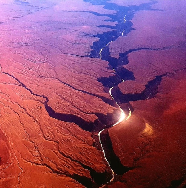 A detailed photo of the Arrokoth KBO, showing its bi-lobed shape and reddish surface, taken by the New Horizons spacecraft during its flyby, highlighting the pristine nature of its surface.