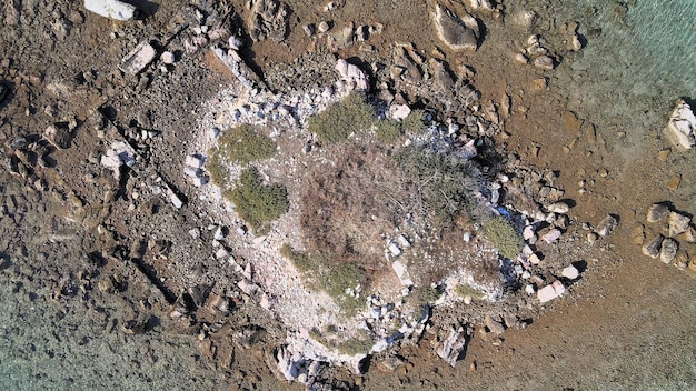 A close-up, detailed view of a satellite surface showing multiple impact craters and signs of damage caused by collisions with small pieces of space debris.