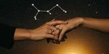 Hands interlocking, symbolizing deep connection and trust, with a Scorpio constellation in a celestial background.