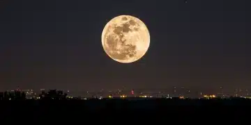 Supermoon rising above a serene landscape in 2026