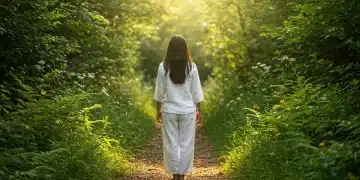Serene person practicing walking meditation in a peaceful, sun-dappled forest path, embodying mental clarity.