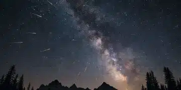 Spectacular meteor shower streaking across a dark night sky with visible Milky Way